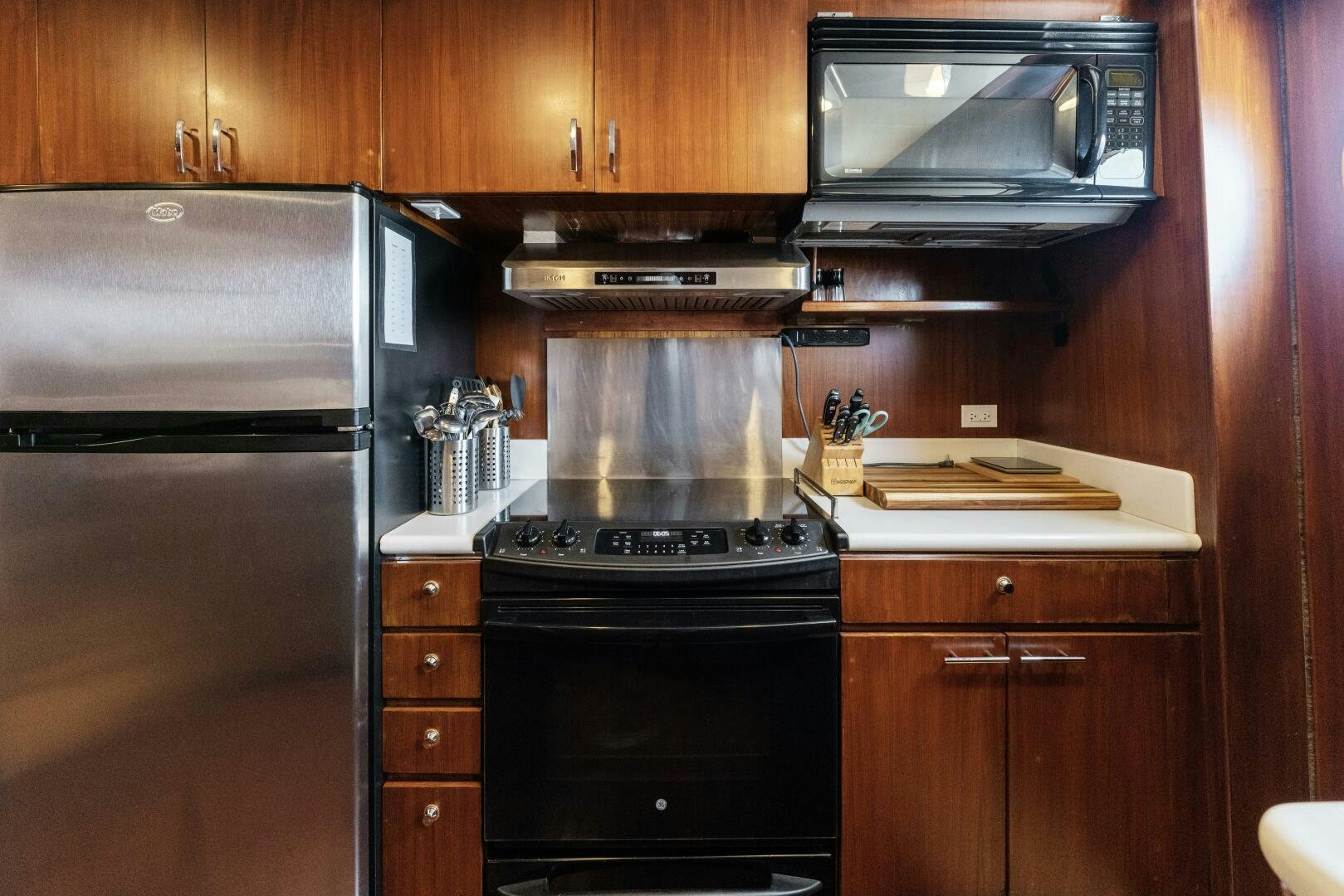 a kitchen with wooden cabinets aboard ARIES Yacht for Sale