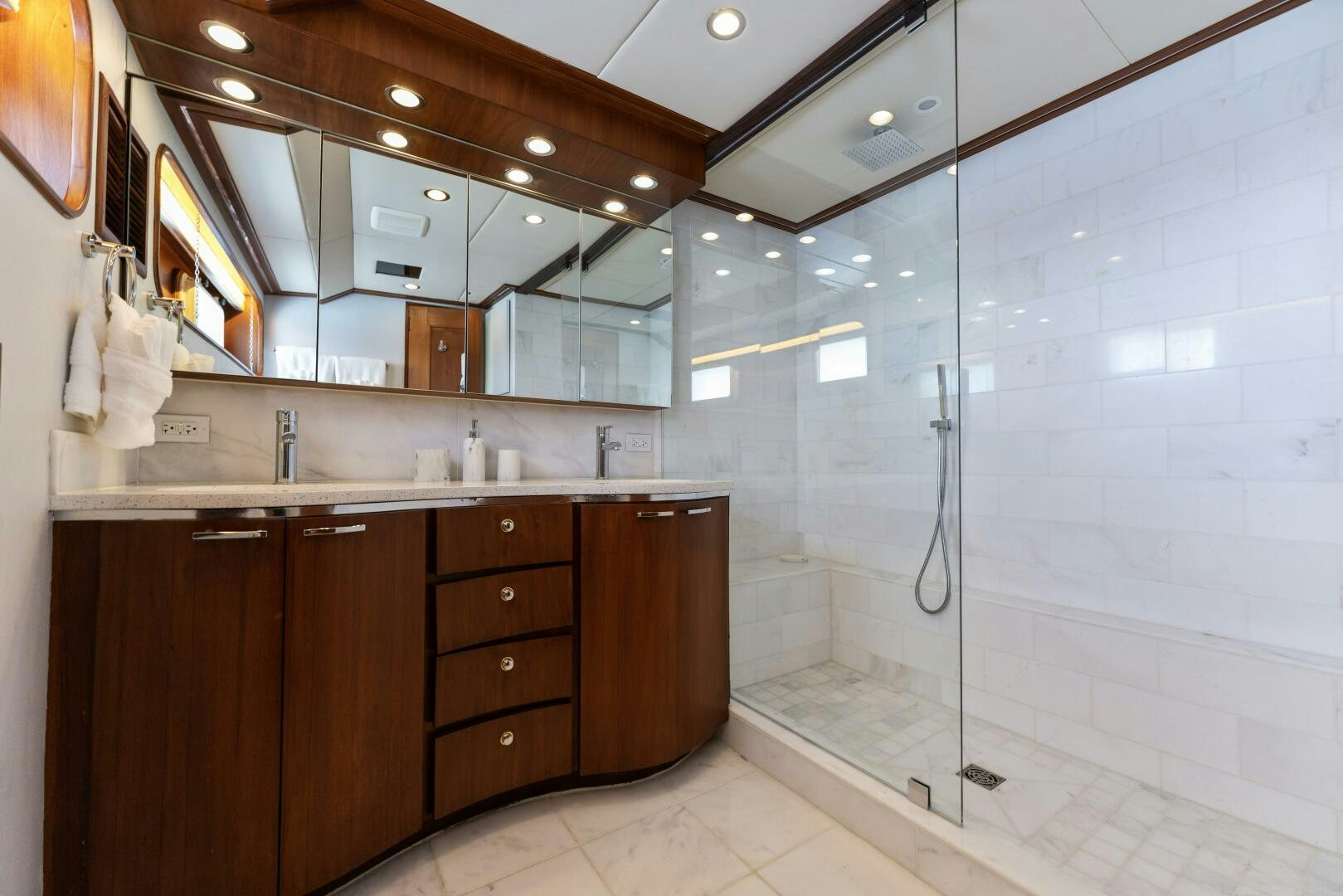 a bathroom with a glass shower aboard ARIES Yacht for Sale