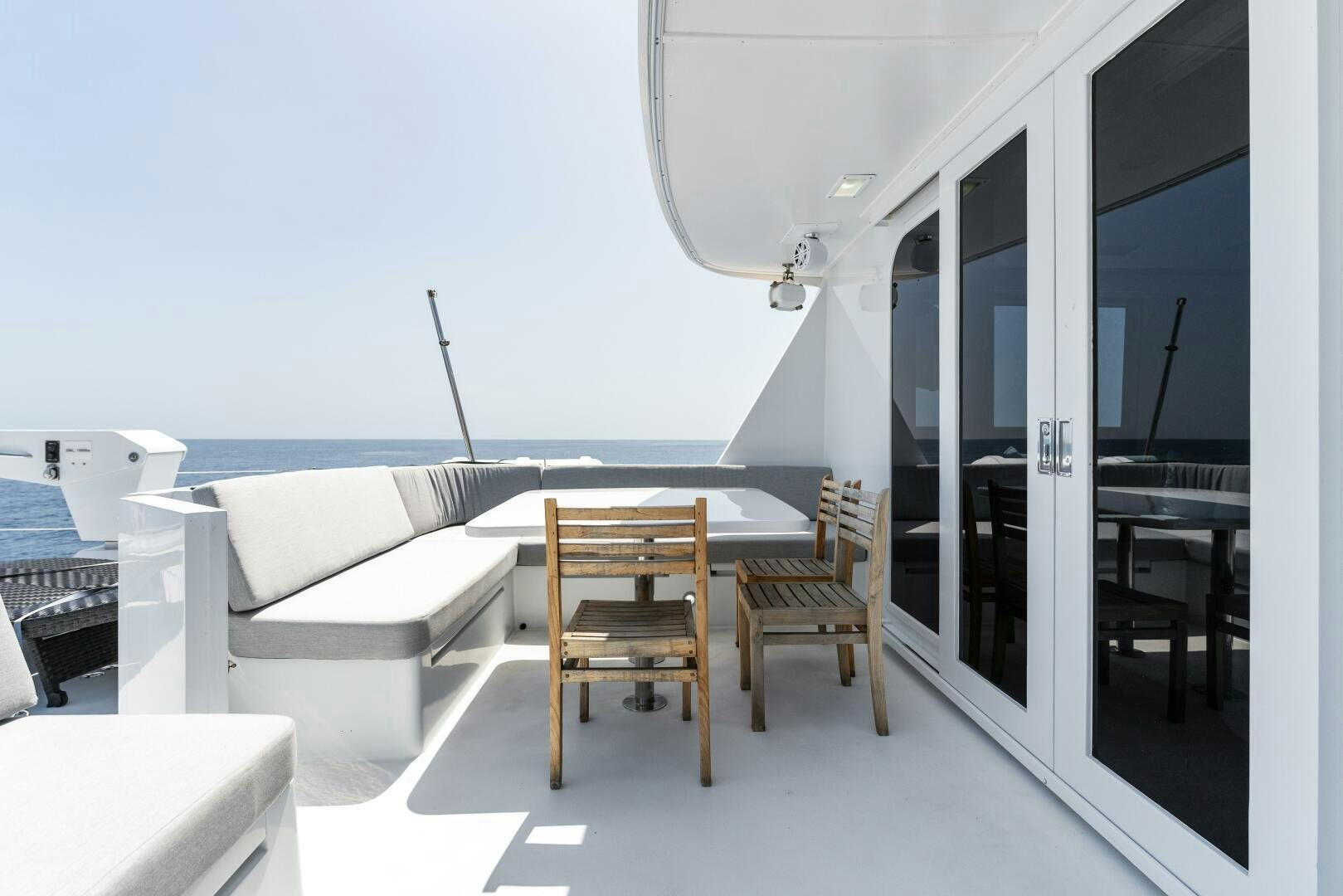 a room with a table and chairs aboard ARIES Yacht for Sale