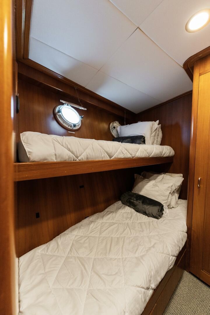 a bed with a white bed spread aboard ARIES Yacht for Sale