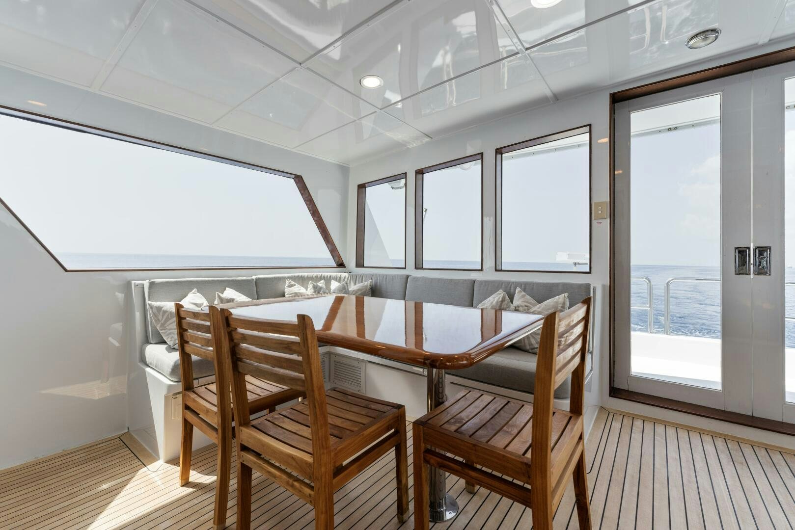 a room with a table and chairs aboard ARIES Yacht for Sale