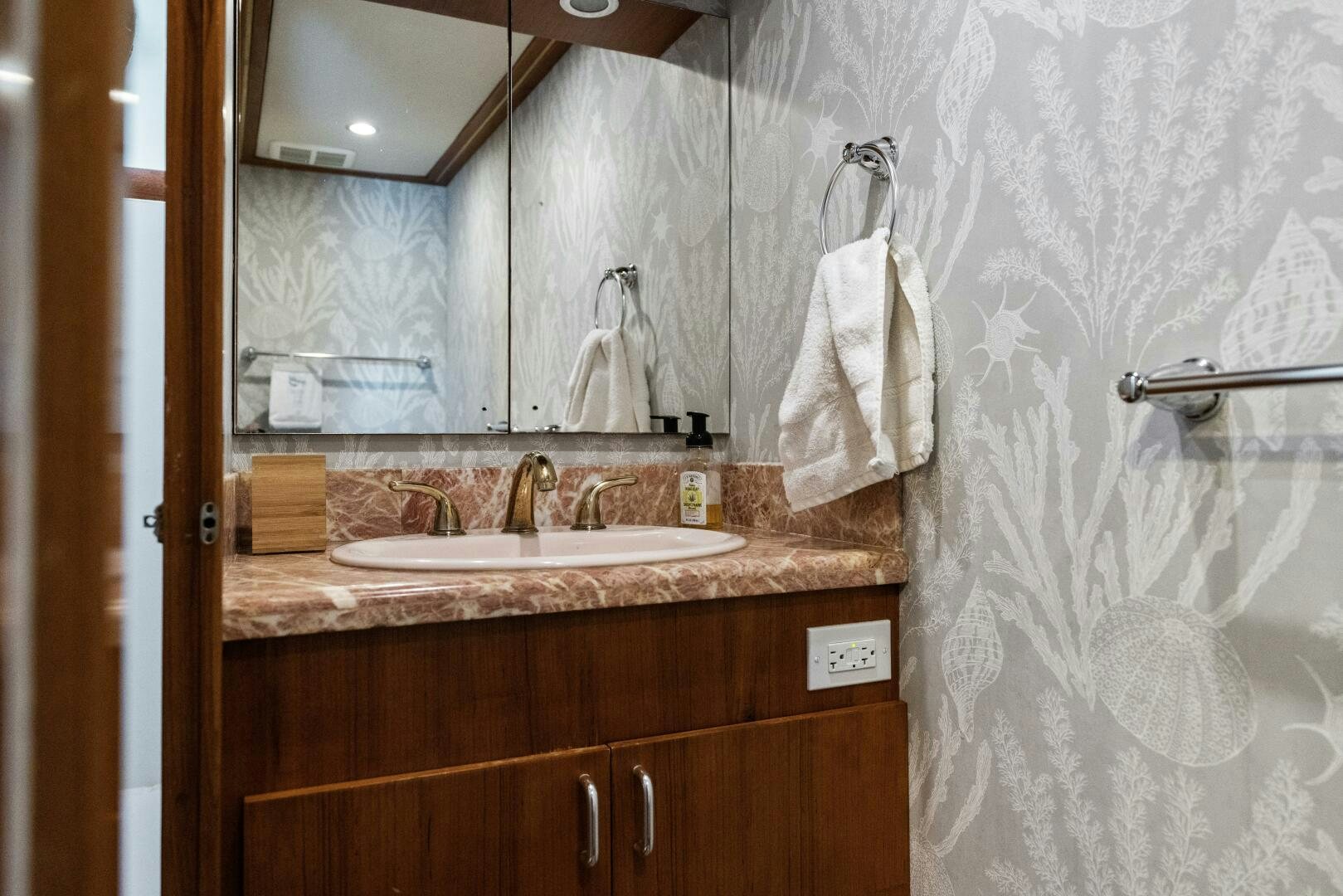 a bathroom with a large mirror aboard ARIES Yacht for Sale