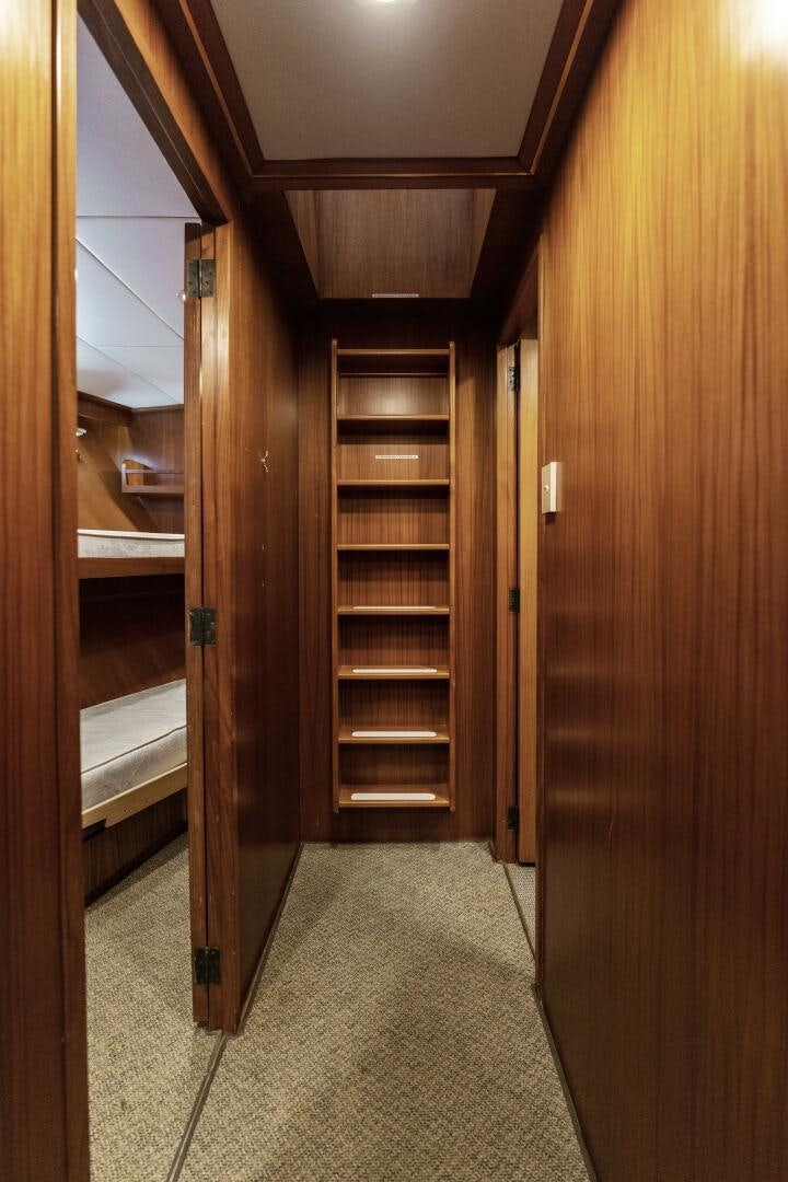 a room with a closet and a shelf with bookshelves aboard ARIES Yacht for Sale