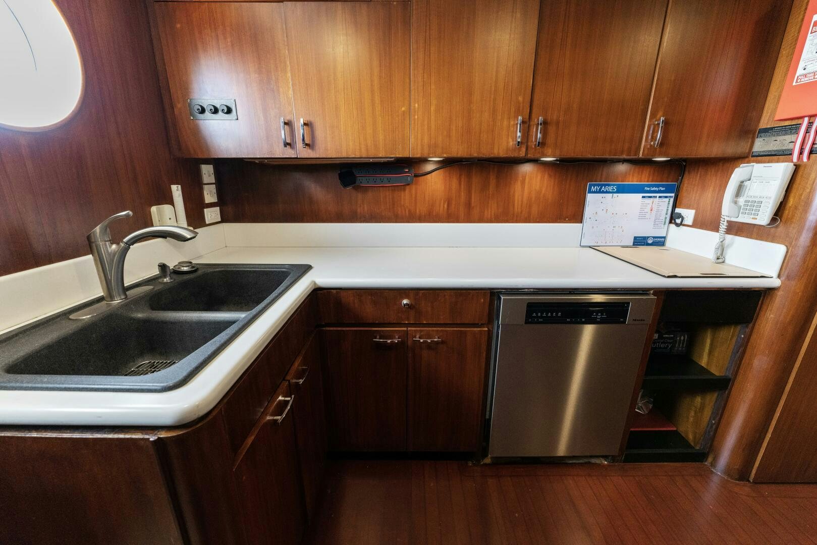 a kitchen with wooden cabinets aboard ARIES Yacht for Sale