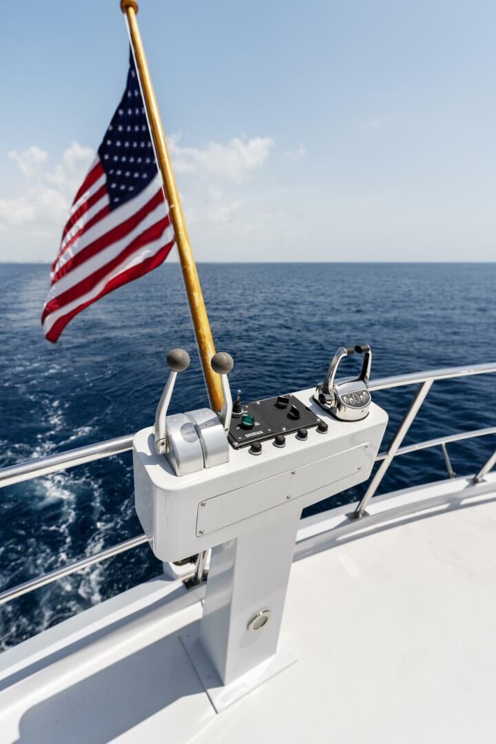 a boat with a flag on the front aboard ARIES Yacht for Sale