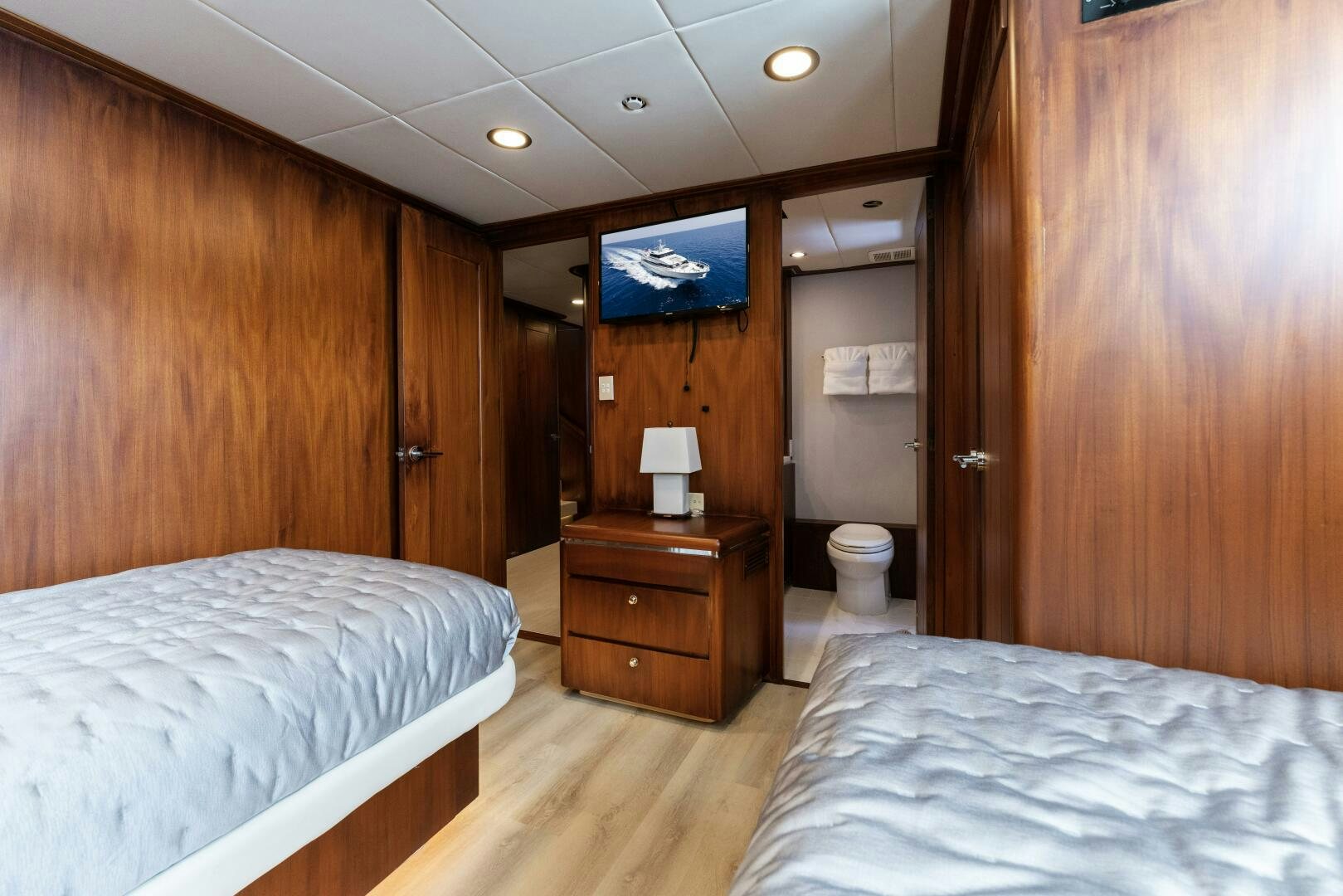 a hotel room with a bed and a television aboard ARIES Yacht for Sale