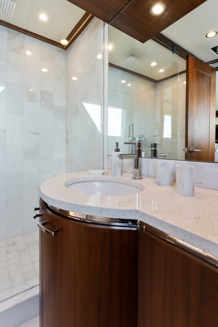 a bathroom with a large mirror aboard ARIES Yacht for Sale