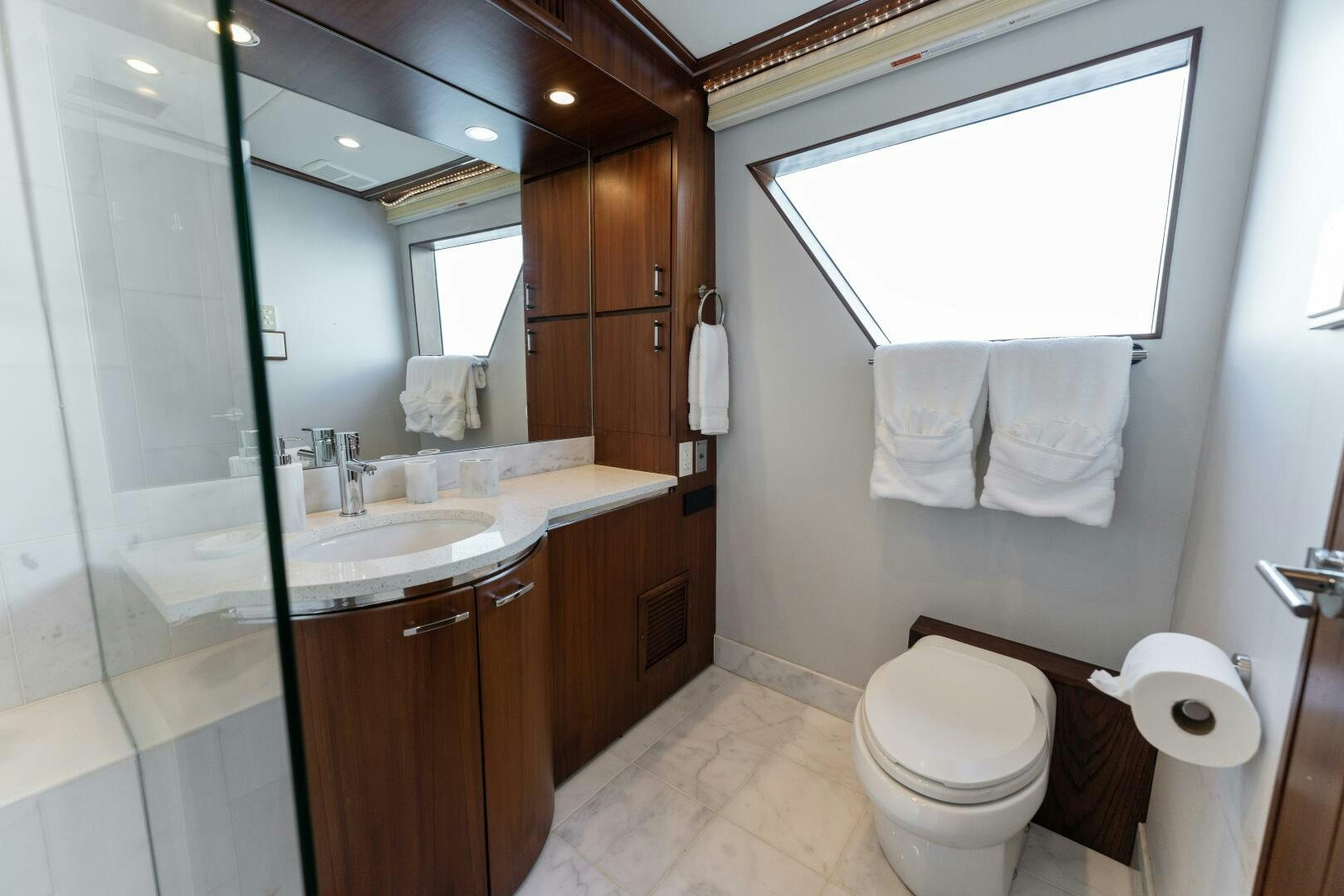 a bathroom with a sink toilet and a mirror aboard ARIES Yacht for Sale