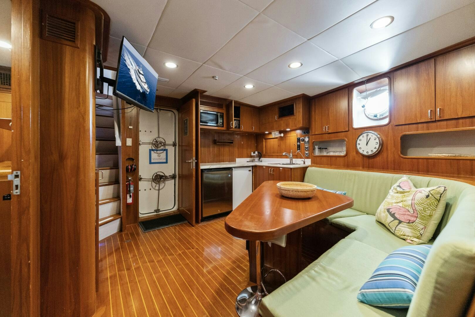 a living room with a table and couches aboard ARIES Yacht for Sale