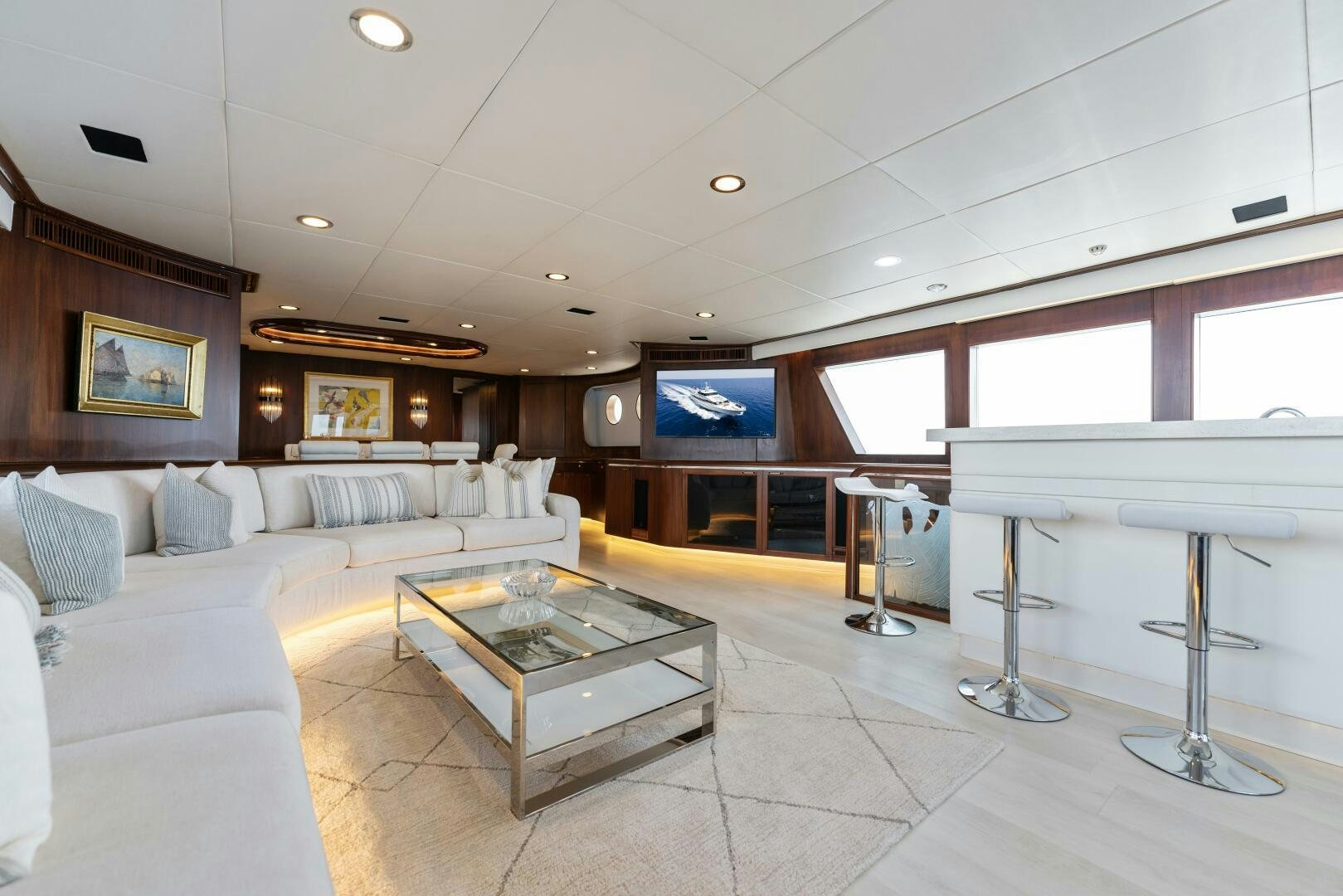 a living room with a large white sofa and a table aboard ARIES Yacht for Sale