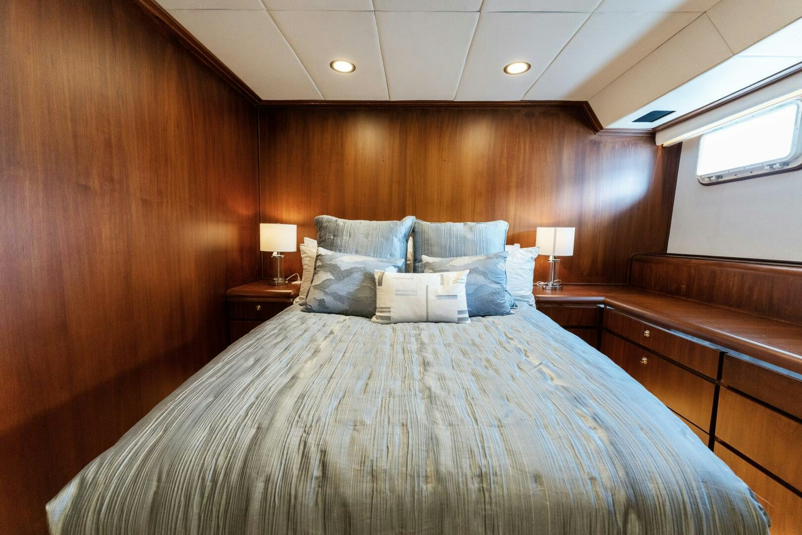 a bed with a wooden headboard aboard ARIES Yacht for Sale