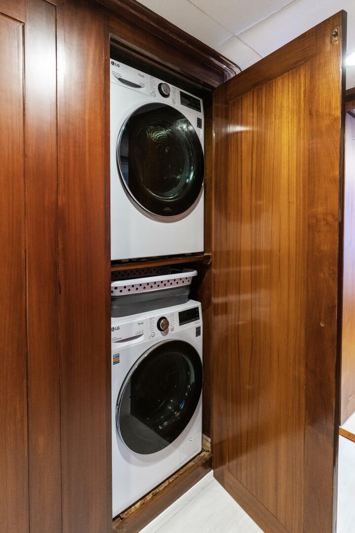 a closet with a washing machine and dryer aboard ARIES Yacht for Sale
