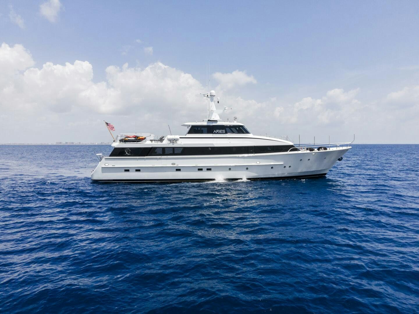 a white yacht in the water aboard ARIES Yacht for Sale