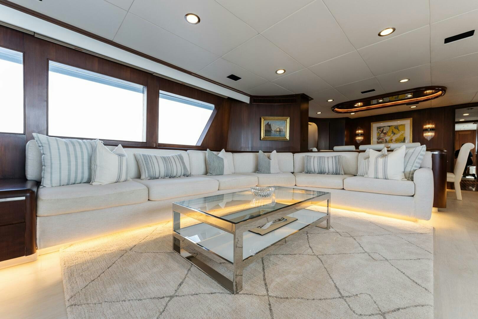 a living room with a large sectional sofa and a coffee table aboard ARIES Yacht for Sale