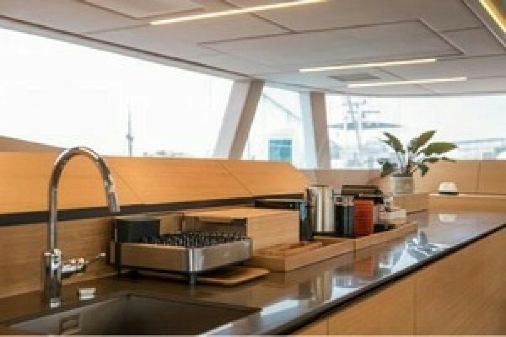 a kitchen with a large island aboard KAILUA Yacht for Sale