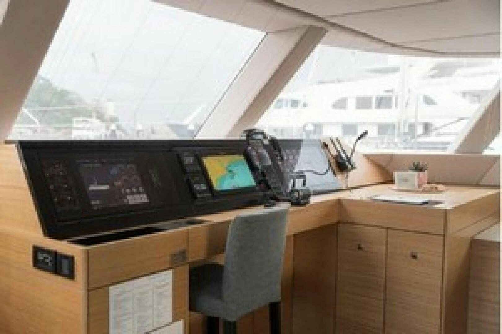 a desk with a computer and a chair aboard KAILUA Yacht for Sale