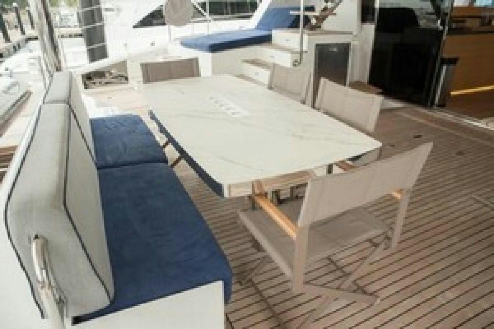a table with chairs around it aboard KAILUA Yacht for Sale