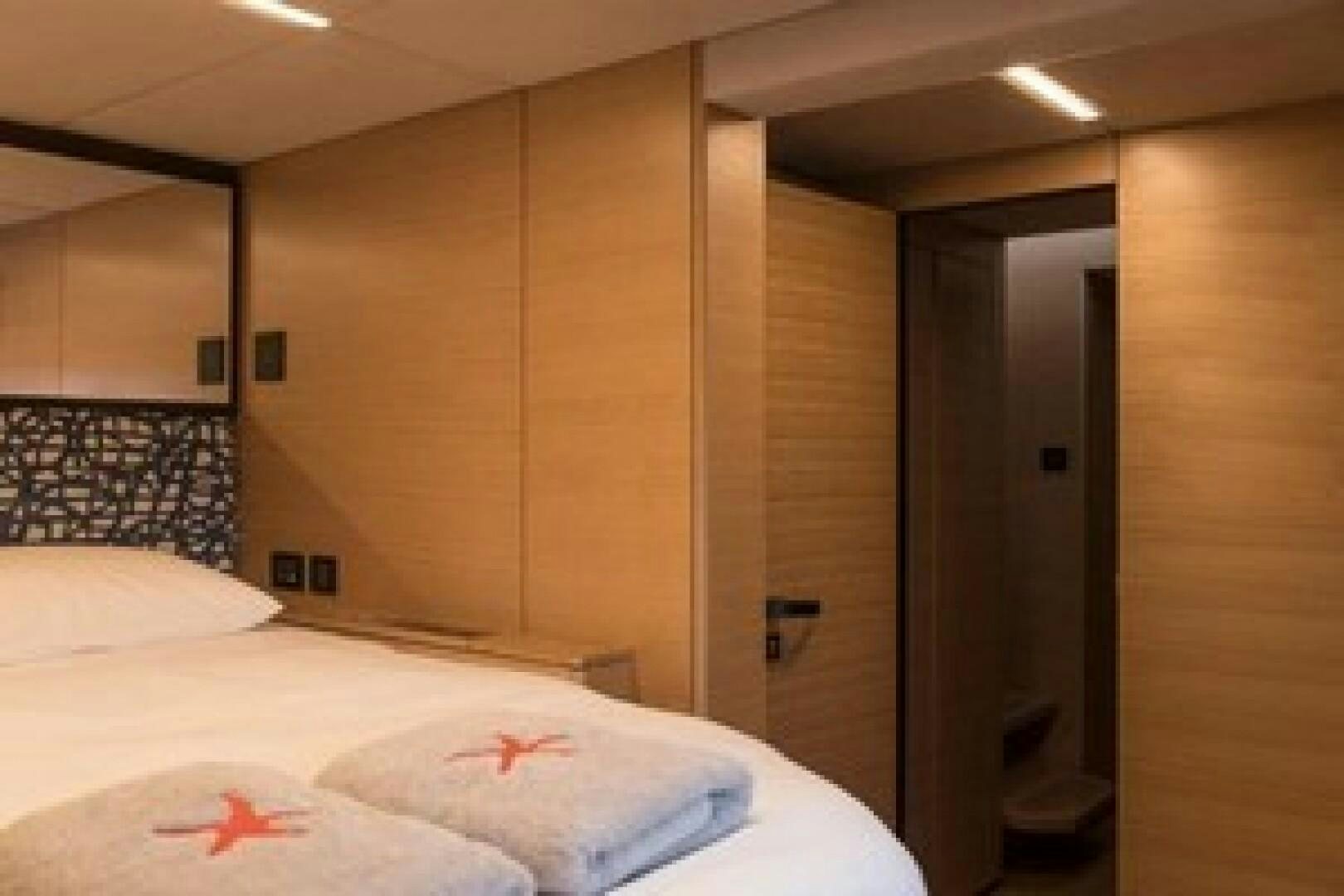 a bedroom with a bed and a closet aboard KAILUA Yacht for Sale