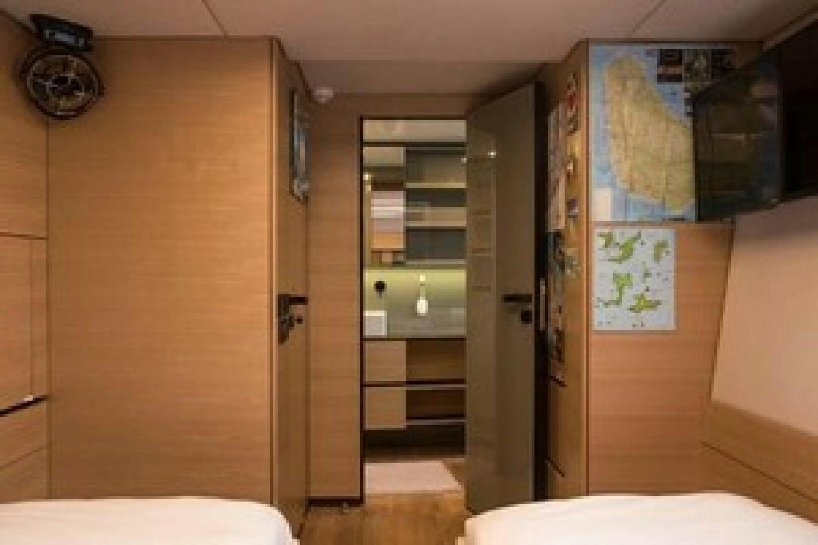a room with a closet and a bed aboard KAILUA Yacht for Sale