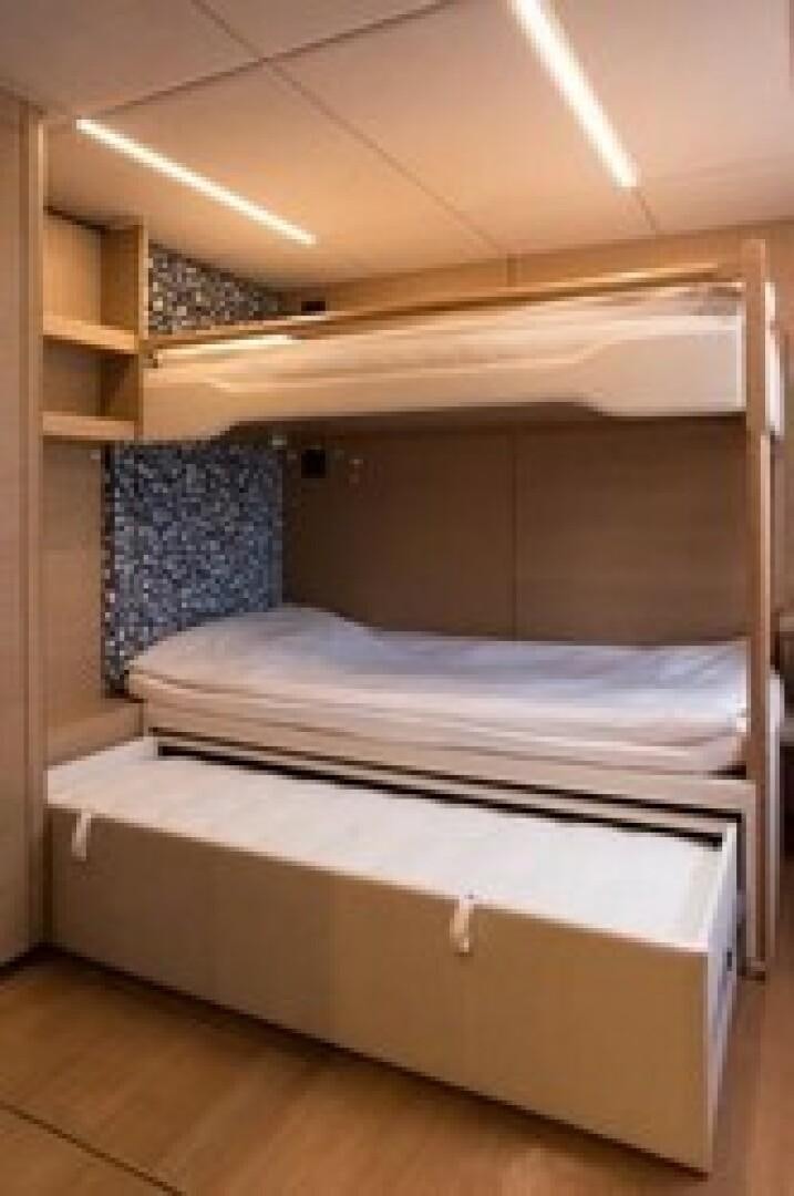 a room with a bed and a shelf aboard KAILUA Yacht for Sale