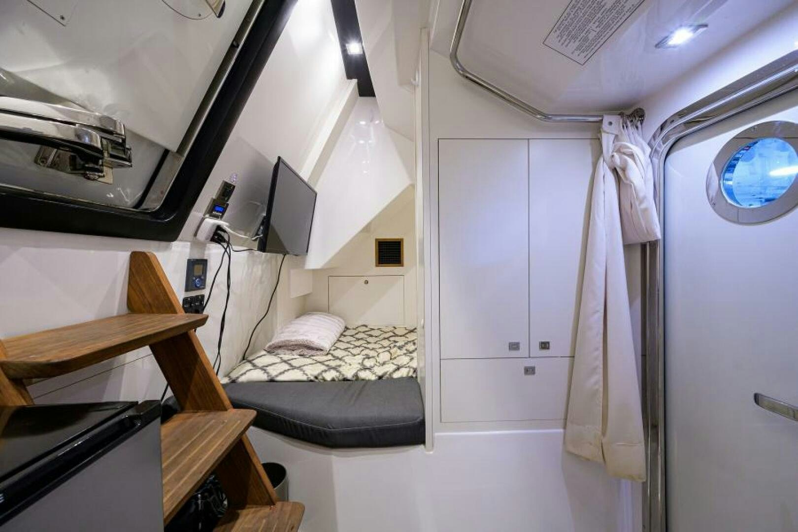 a small room with a bed and a desk aboard JOHN BOAT Yacht for Sale