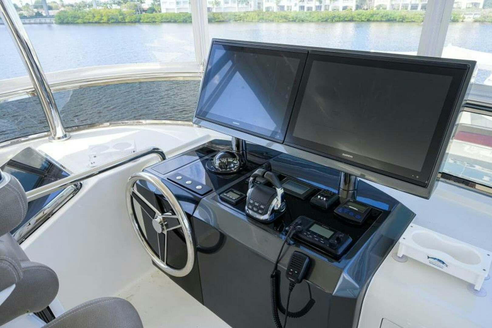a car with a computer monitor and a couple of monitors on it aboard JOHN BOAT Yacht for Sale