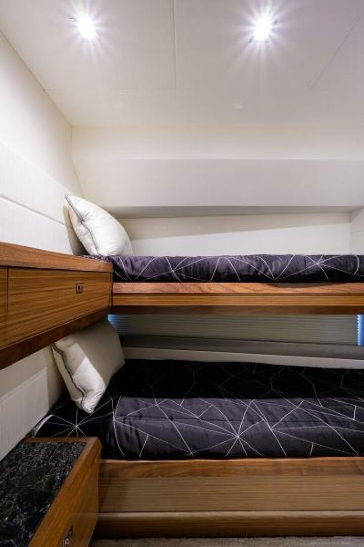 a bed with a blue comforter aboard JOHN BOAT Yacht for Sale