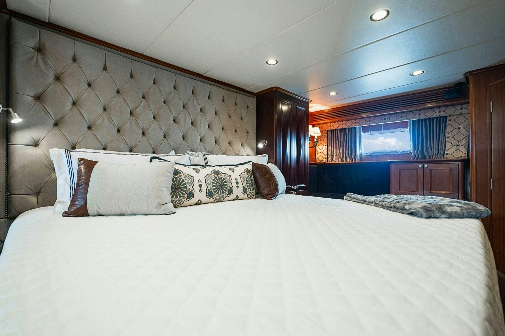 a bed with a white bed spread aboard MOONSHOT Yacht for Sale