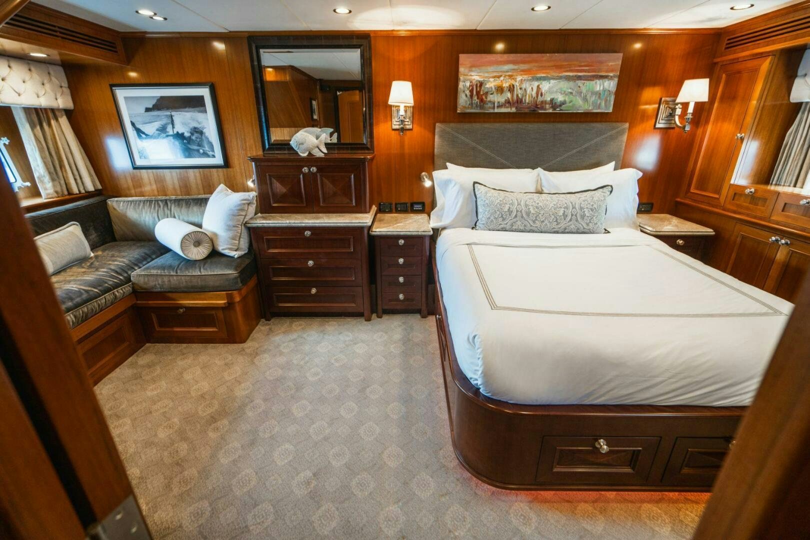 a large bedroom with a bed and a couch aboard MOONSHOT Yacht for Sale