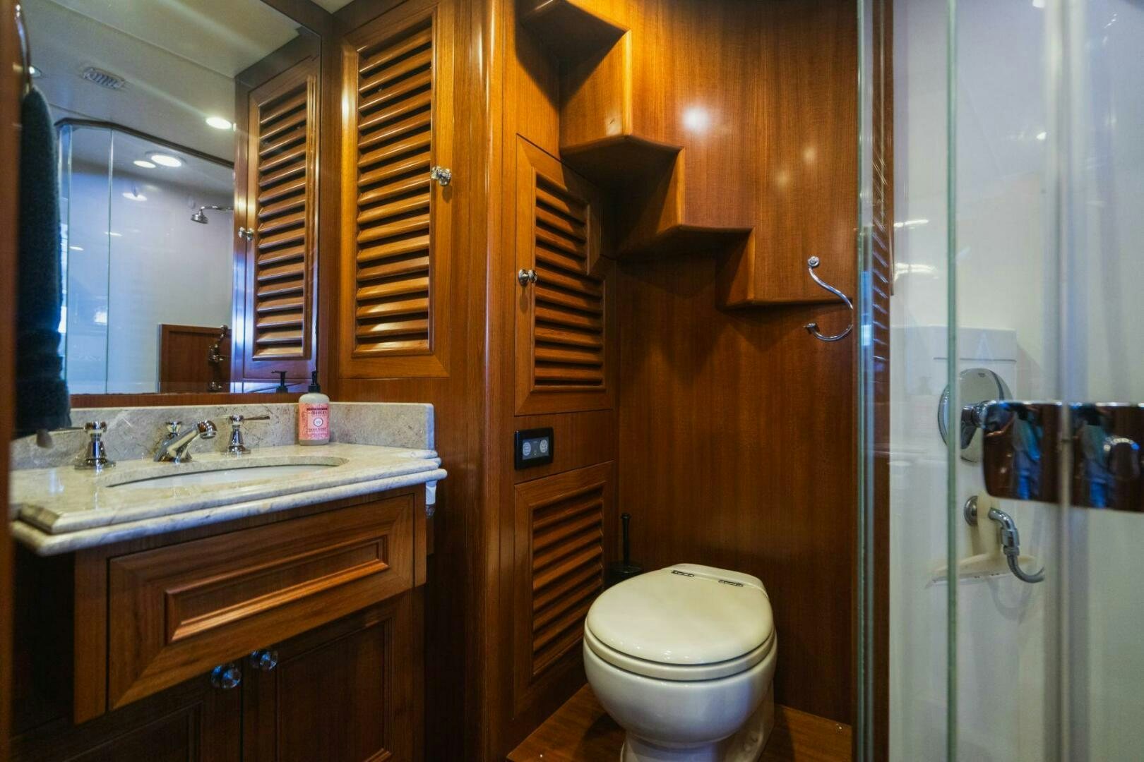 a bathroom with a toilet and sink aboard MOONSHOT Yacht for Sale