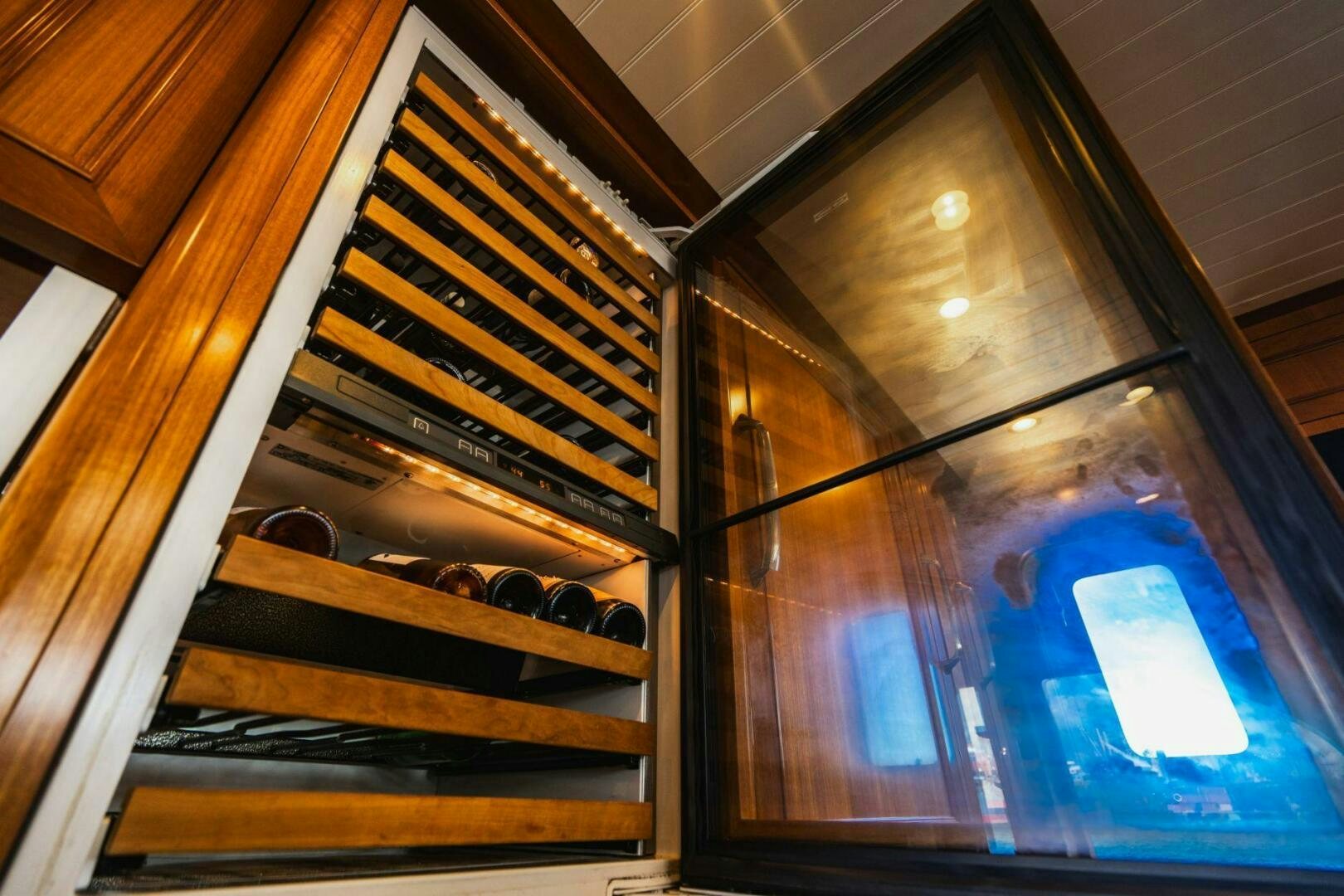 a wooden staircase with a glass window aboard MOONSHOT Yacht for Sale