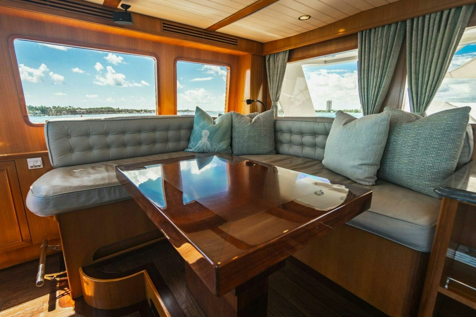 a living room with a couch and a table aboard MOONSHOT Yacht for Sale