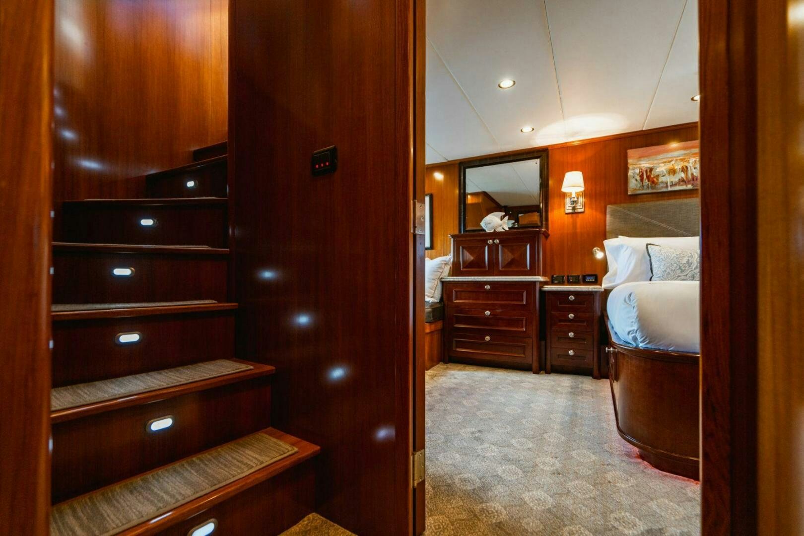 a bedroom with wood cabinets aboard MOONSHOT Yacht for Sale