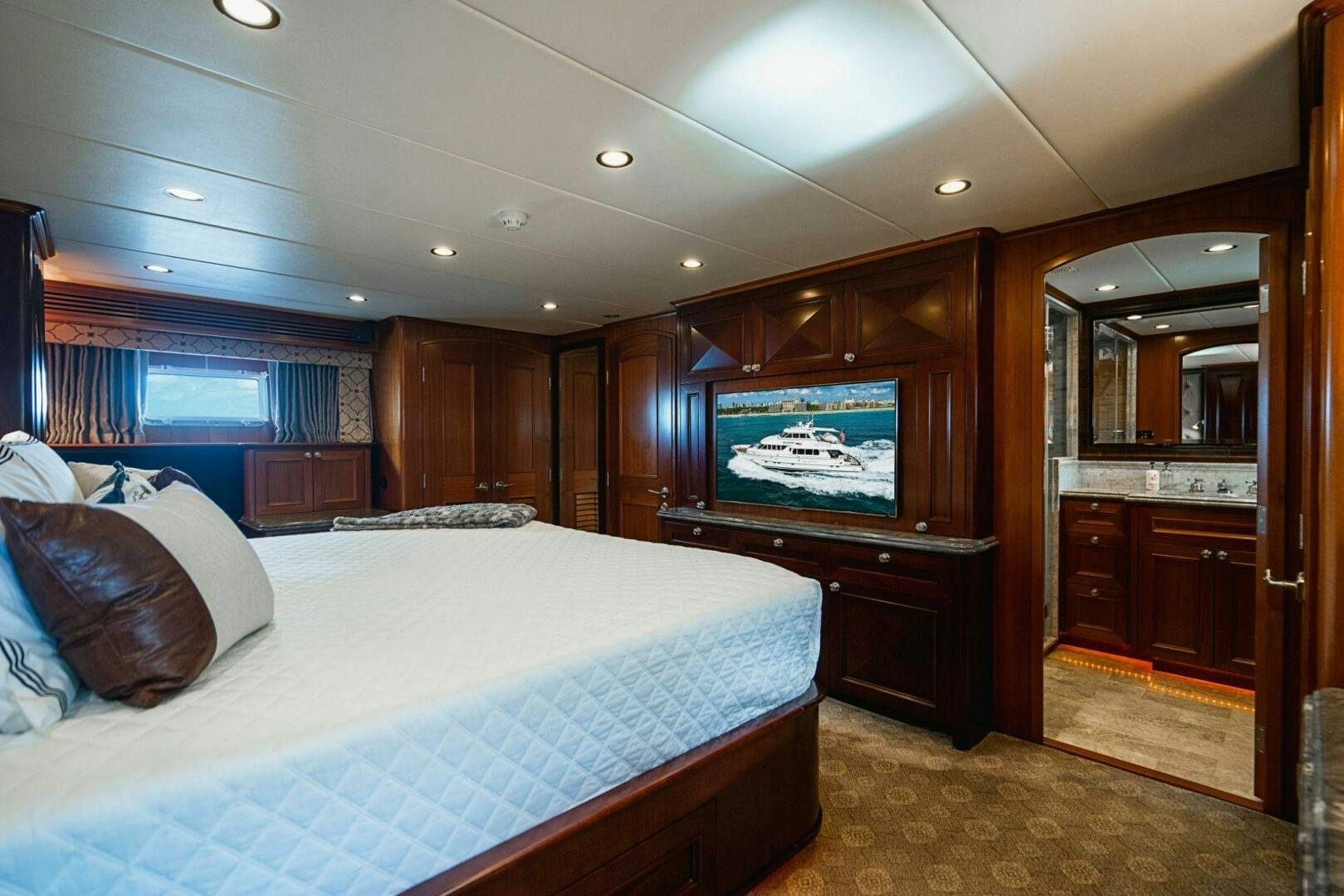 a bedroom with a bed and a tv aboard MOONSHOT Yacht for Sale