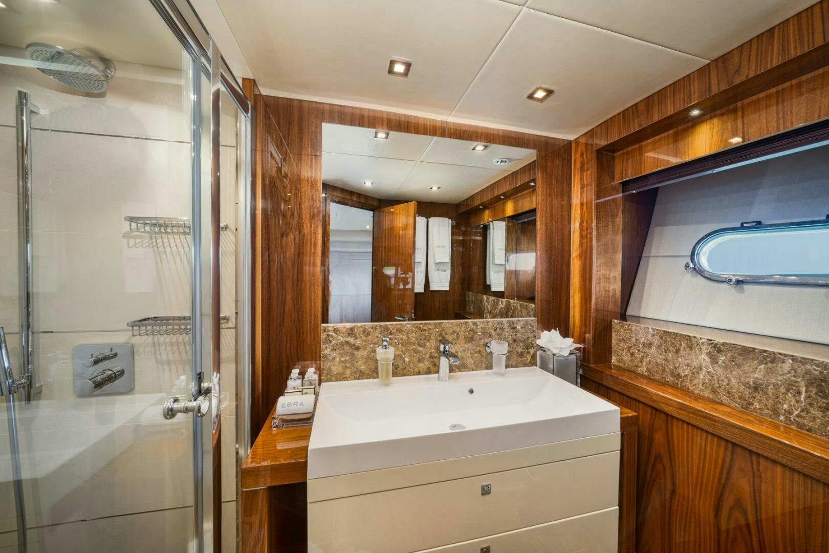 a bathroom with a glass shower aboard EBRA Yacht for Sale
