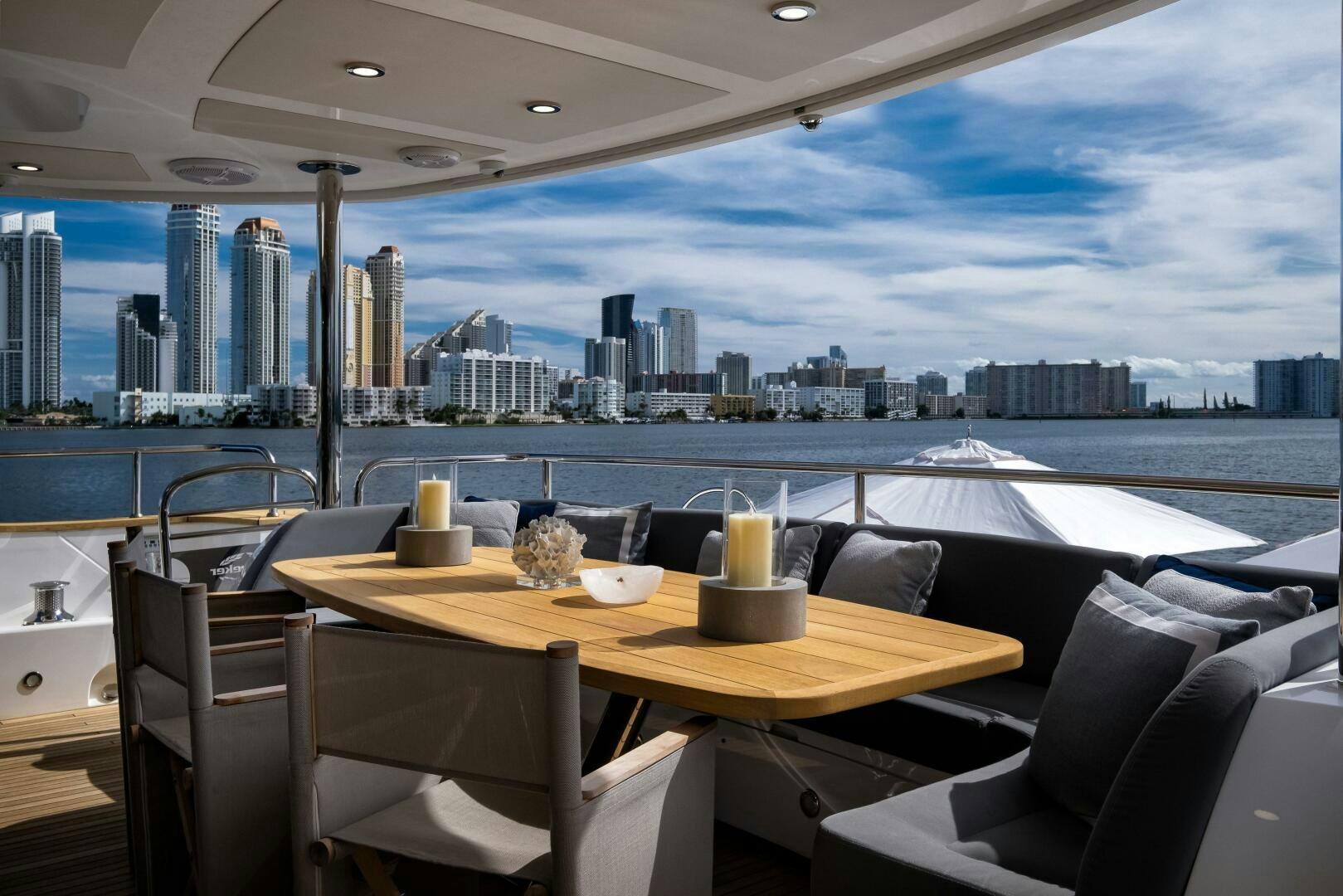 a table with chairs and a view of a city aboard EBRA Yacht for Sale