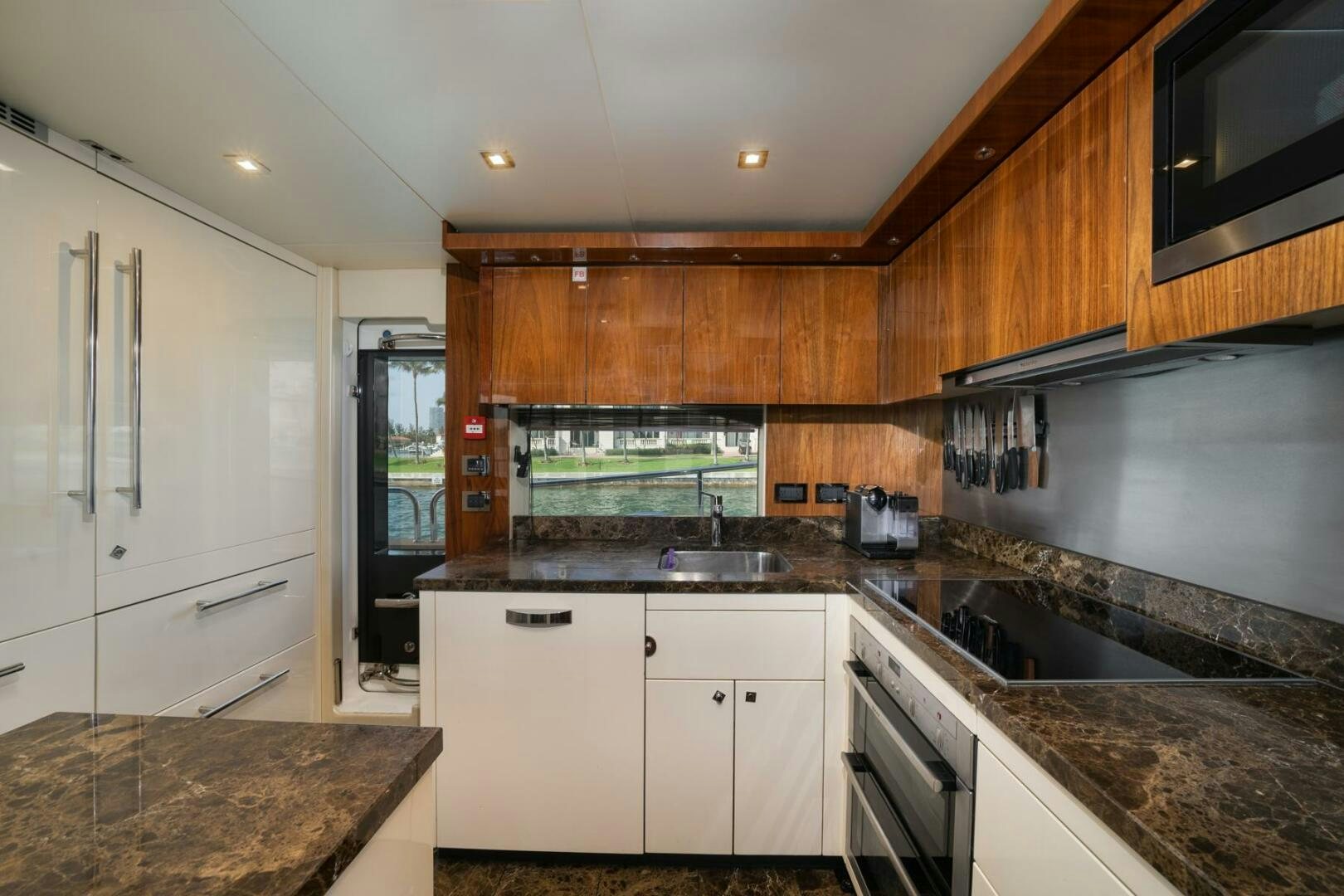 a kitchen with white cabinets aboard EBRA Yacht for Sale