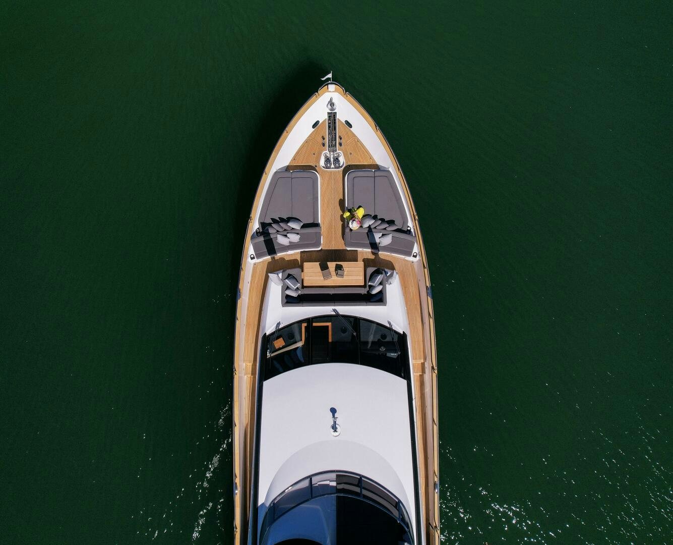 a white and gold boat on water aboard EBRA Yacht for Sale
