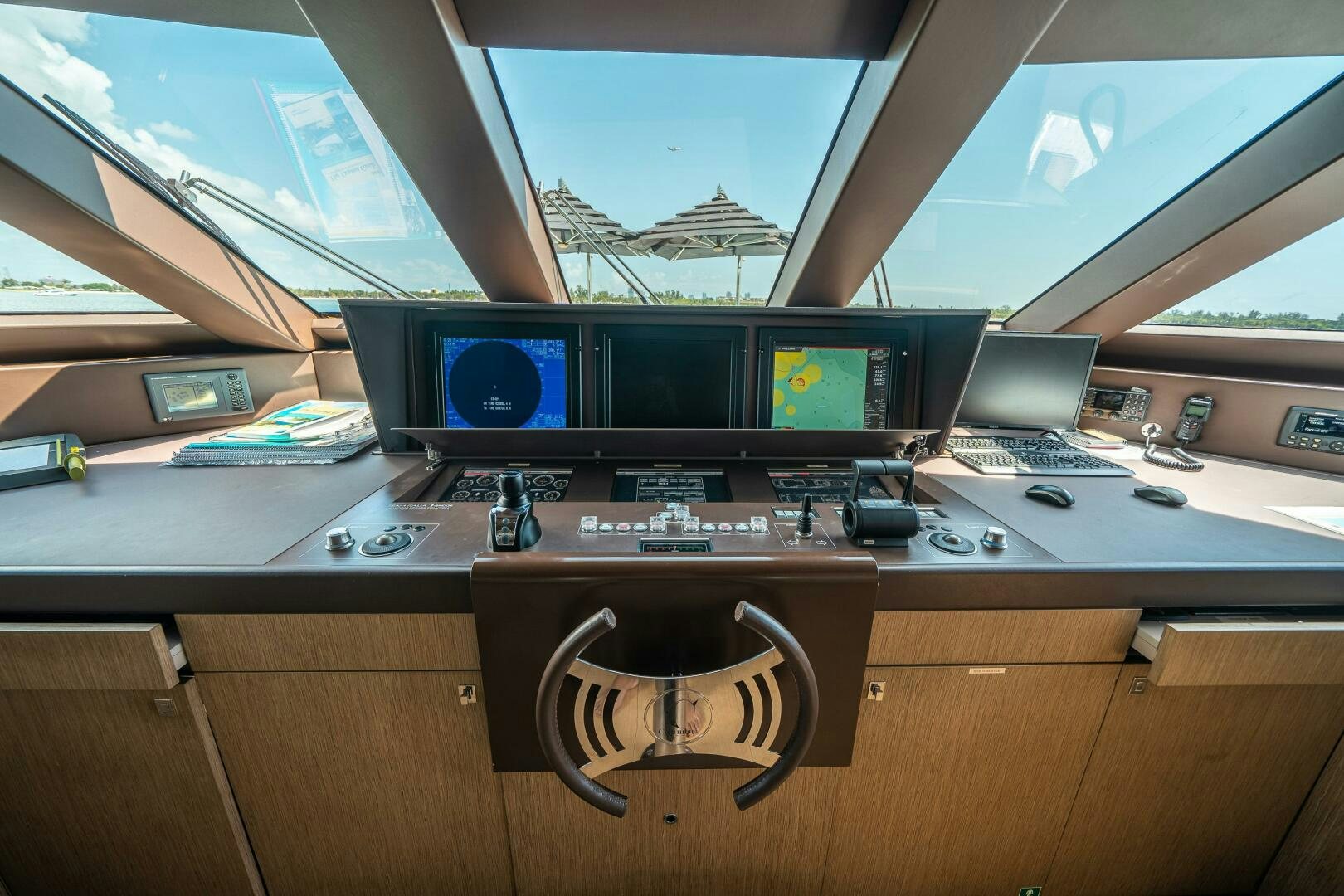 a computer desk with a laptop and monitor on it aboard LEUDIN I Yacht for Sale