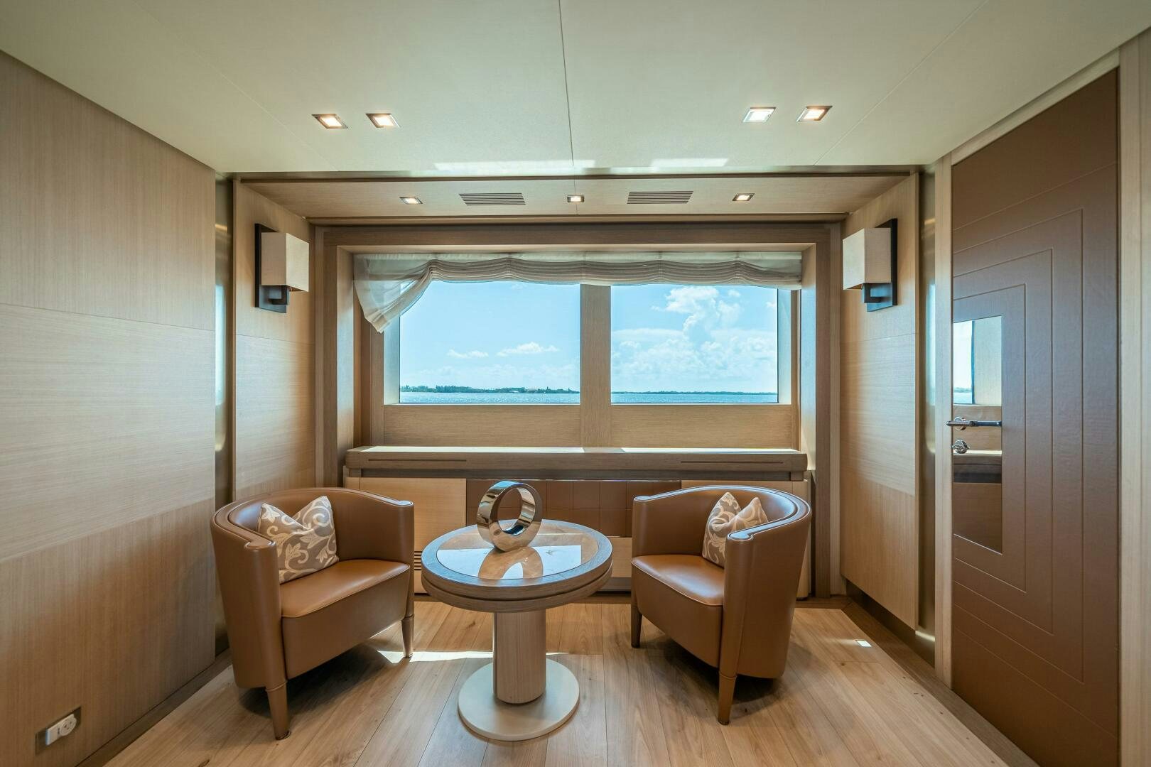 a living room with a table and chairs aboard LEUDIN I Yacht for Sale