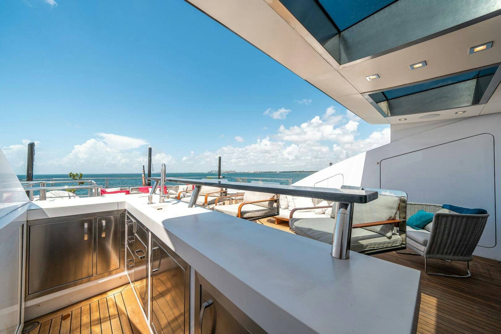 a deck with a view of the ocean and a city aboard LEUDIN I Yacht for Sale