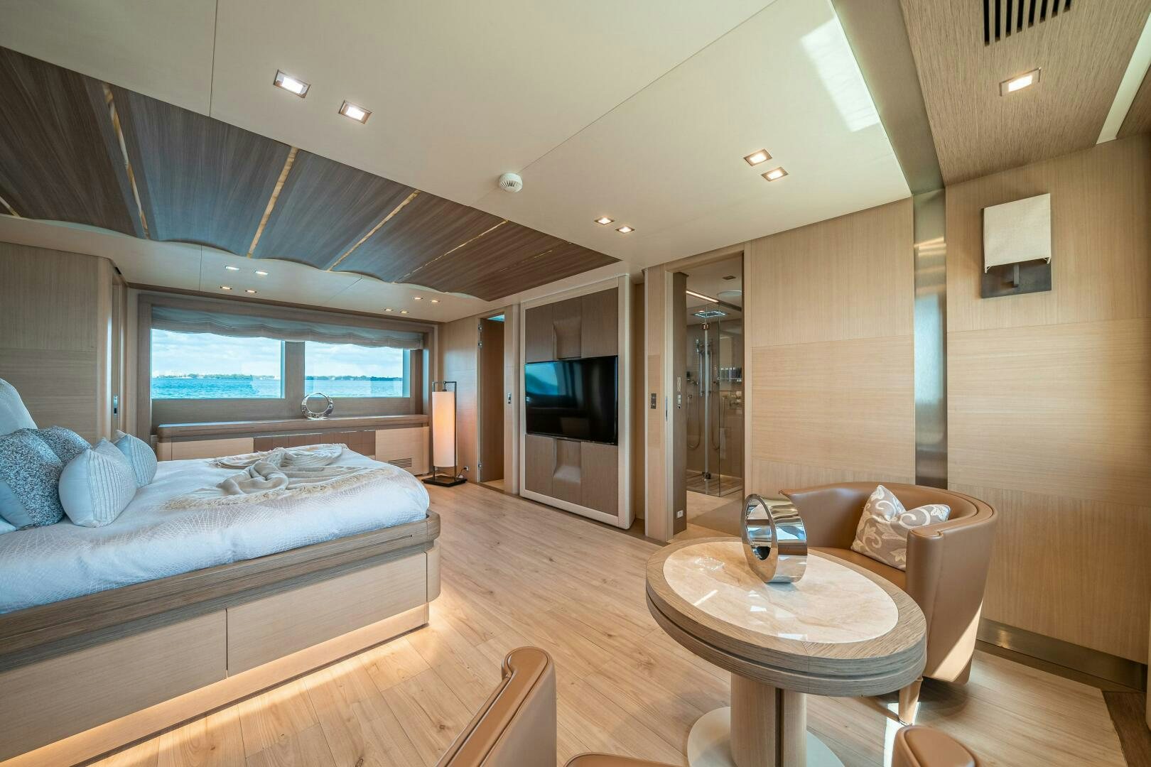 a bedroom with a bed and a table aboard LEUDIN I Yacht for Sale