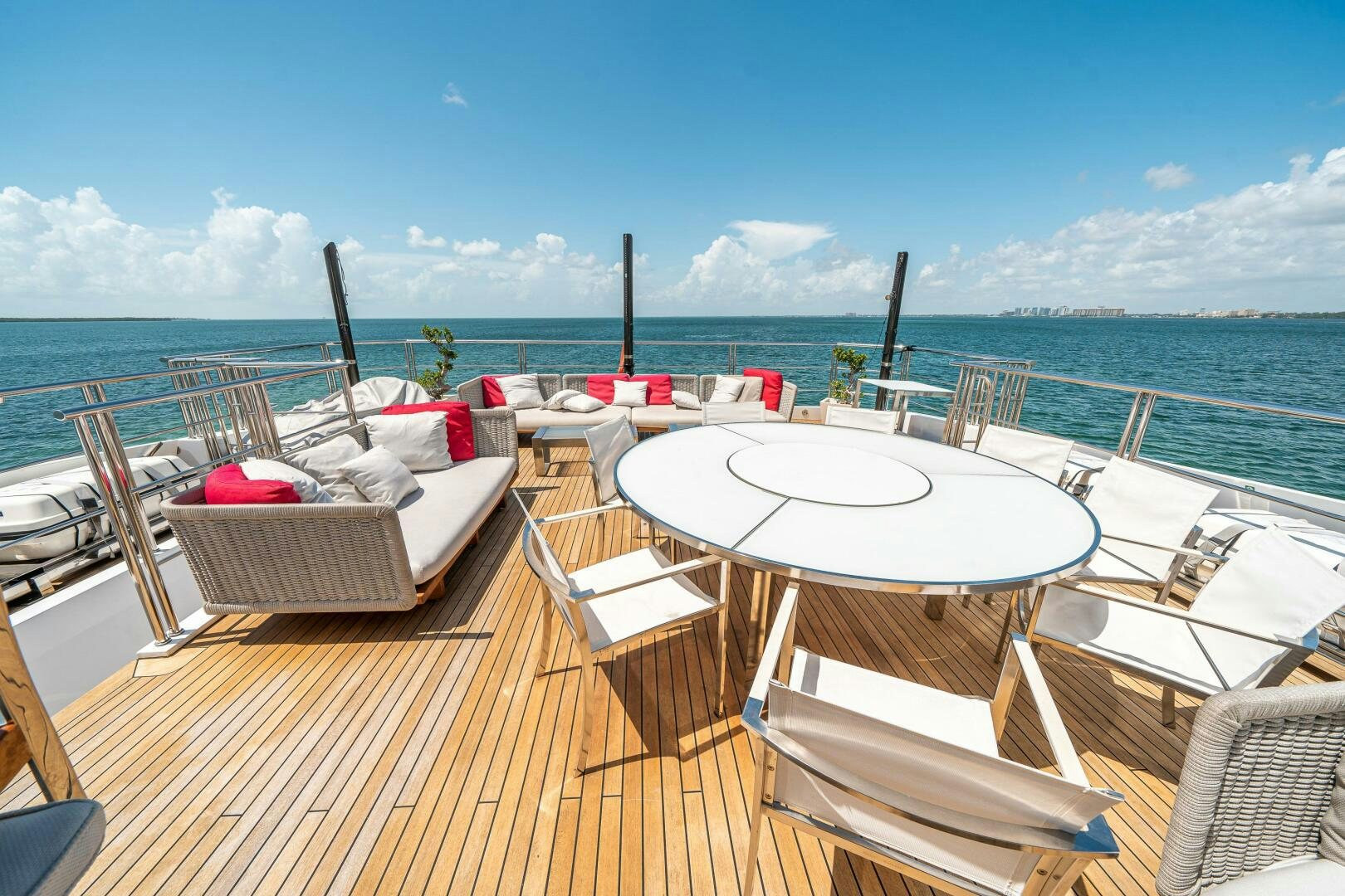 a deck with chairs and tables on it by the water aboard LEUDIN I Yacht for Sale