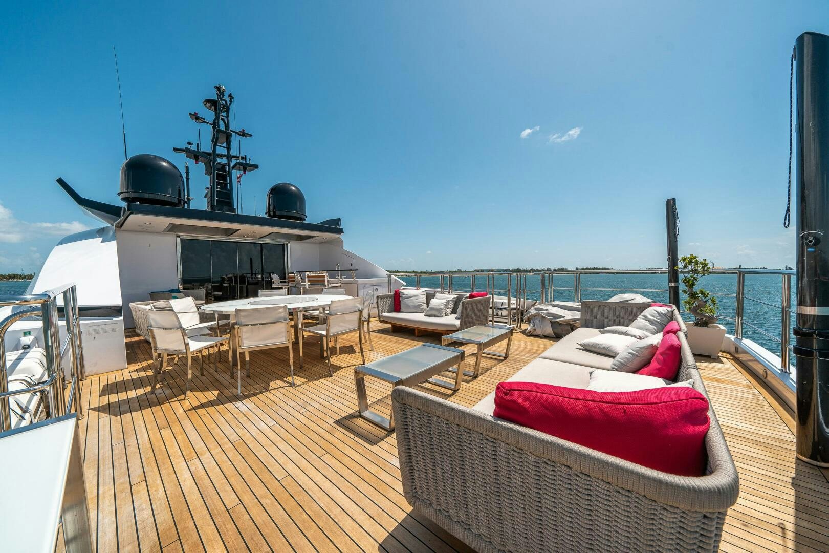a deck with a deck and a large ship in the background aboard LEUDIN I Yacht for Sale