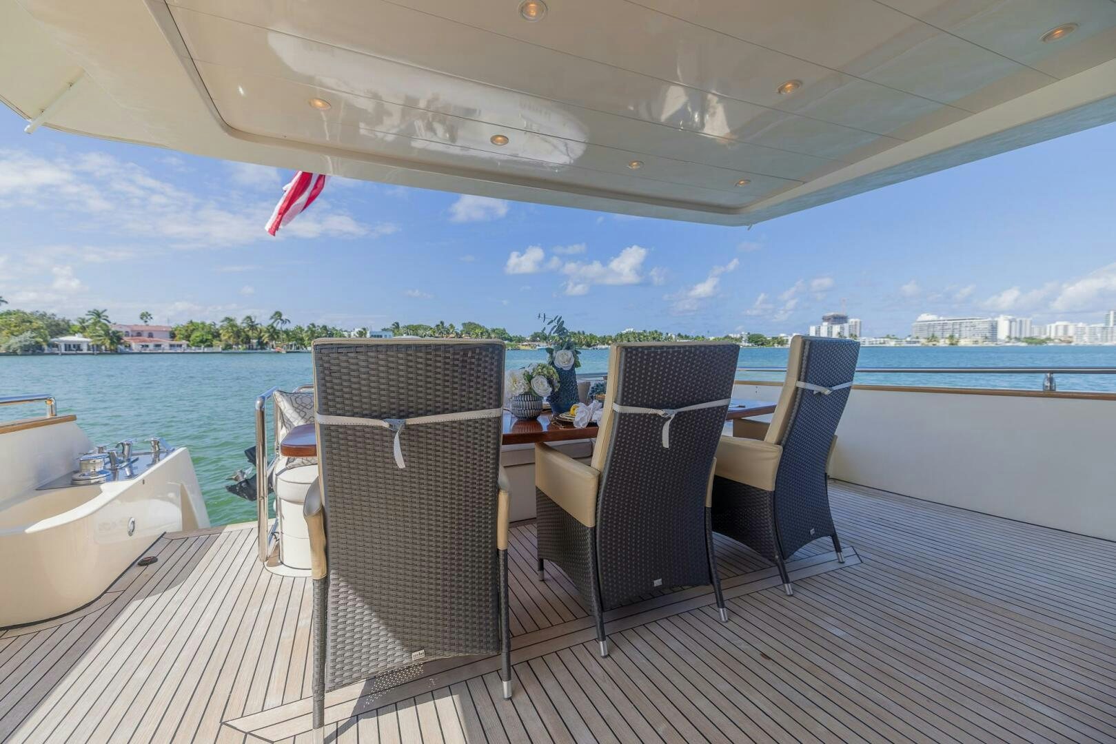 a deck with chairs and a body of water aboard BOULOS Yacht for Sale