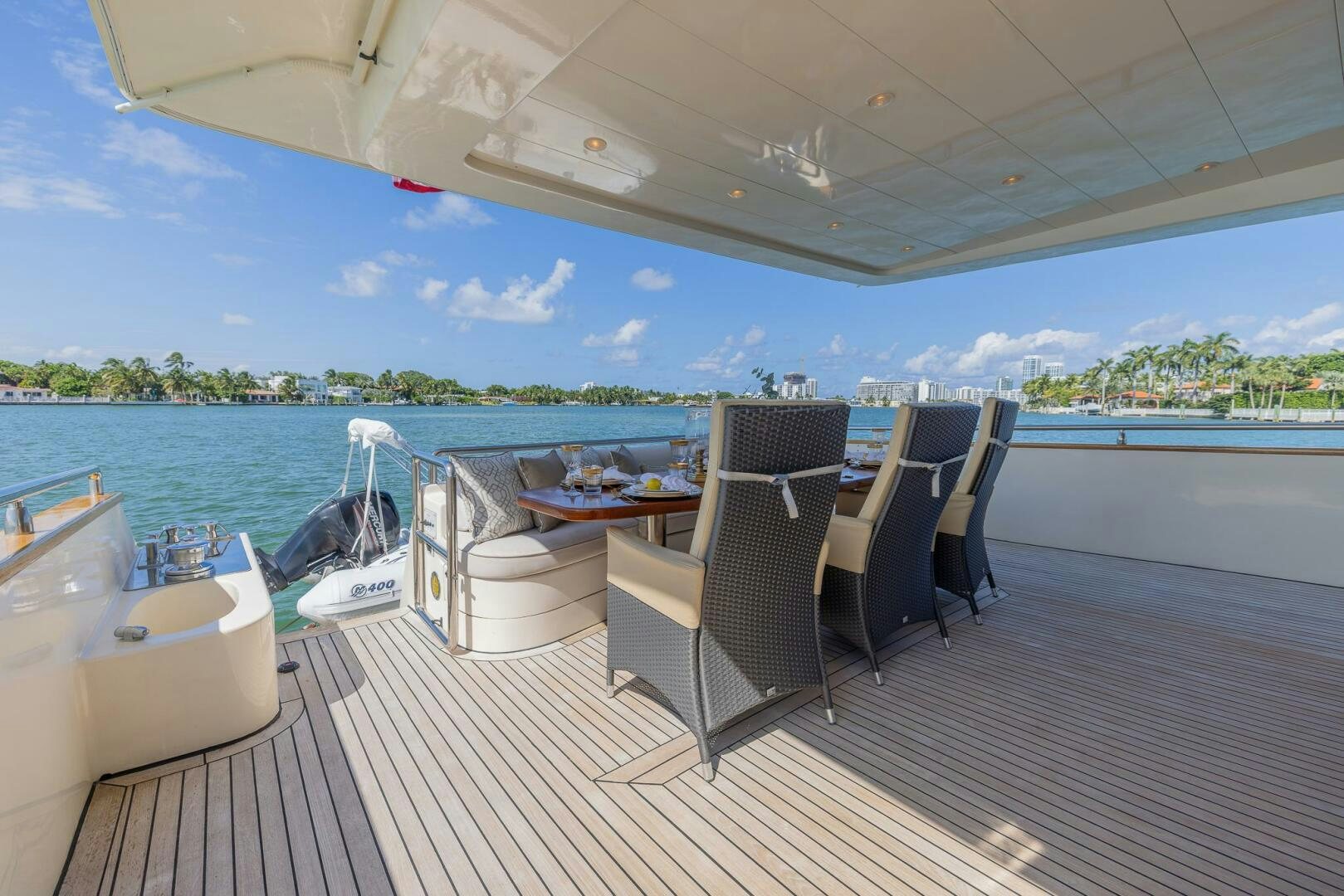 a deck with a table chairs and a pool aboard BOULOS Yacht for Sale