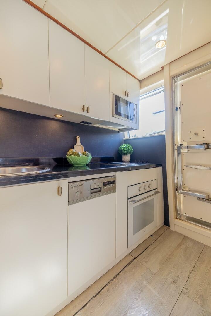 a kitchen with white cabinets aboard BOULOS Yacht for Sale