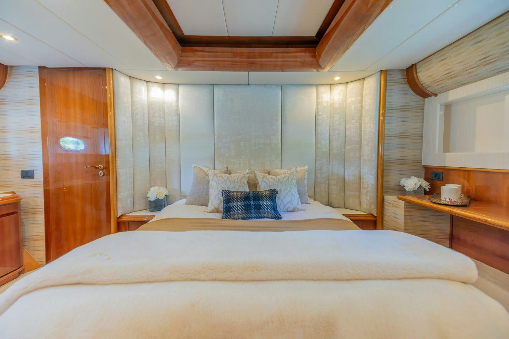 a bed with a white bed spread aboard BOULOS Yacht for Sale