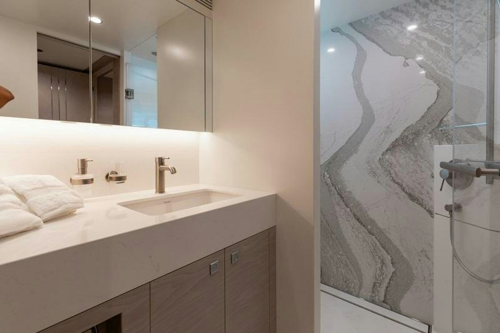 a bathroom with a large mirror aboard WIGGLE ROOM Yacht for Sale