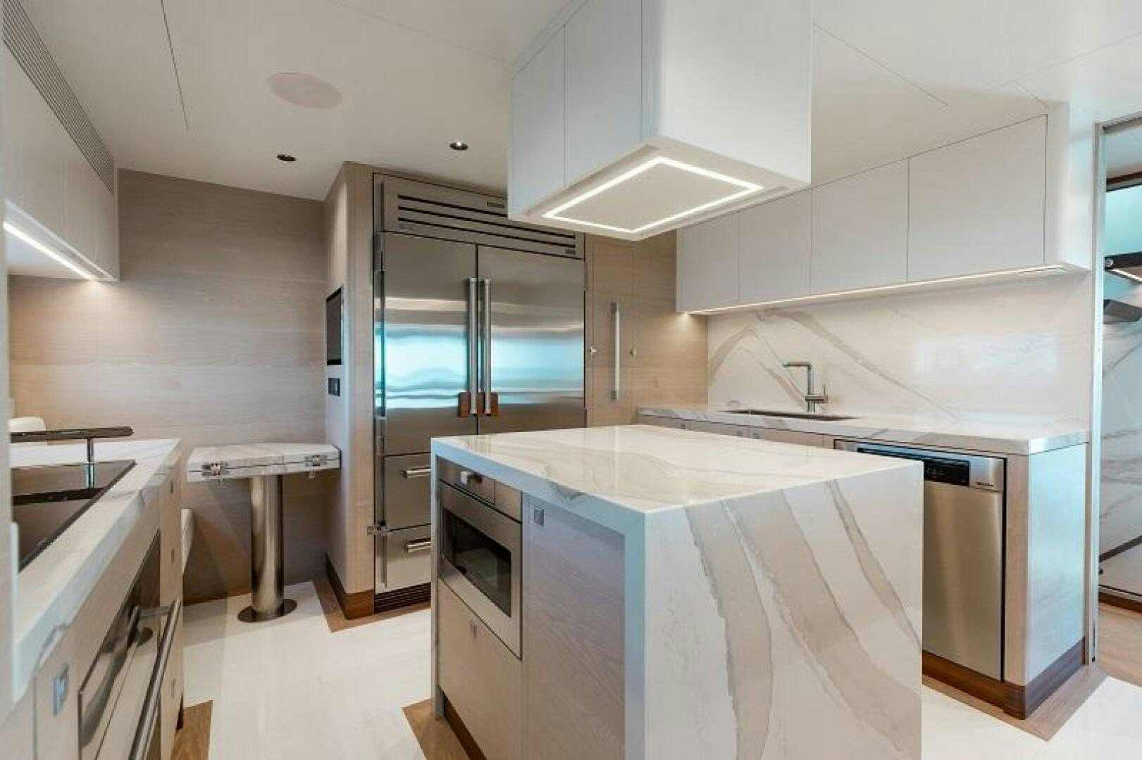 a kitchen with white cabinets aboard WIGGLE ROOM Yacht for Sale